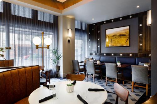 a restaurant with tables and chairs and a large window at The Barfield, Autograph Collection in Amarillo