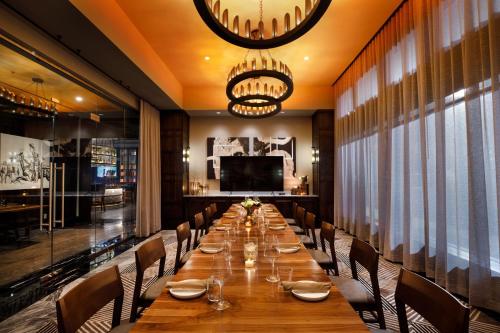 a long dining room with a long table and chairs at The Barfield, Autograph Collection in Amarillo
