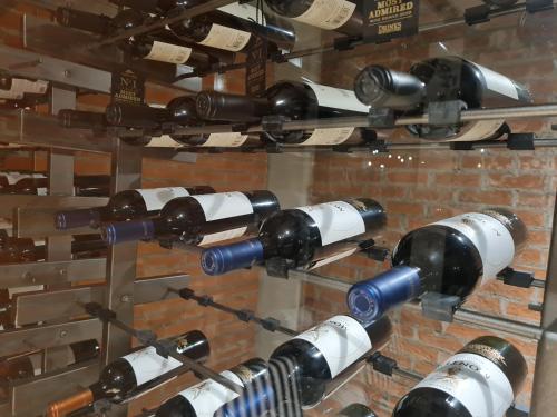 a bunch of wine bottles on a wall at Apartamento moderno 2 habitaciones y 2 baños area Cayala y Embajada USA in Guatemala