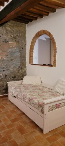 a bedroom with a bed with a mirror on the wall at Casa Nolè in Santa Luce