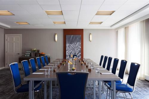 a conference room with a long table and blue chairs at Boston Marriott Long Wharf in Boston