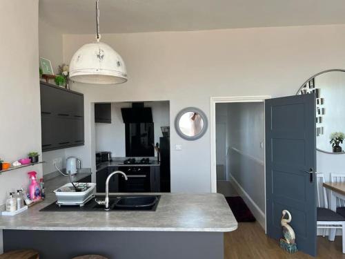 a kitchen with a sink and a counter top at SkyLine Beautiful Apartment in Hastings