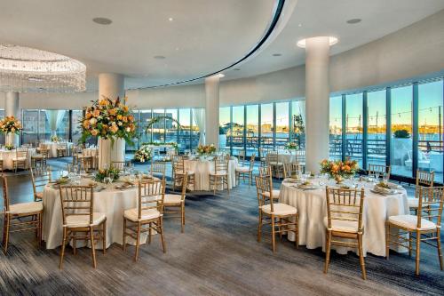 a banquet room with tables and chairs and windows at Boston Marriott Long Wharf in Boston