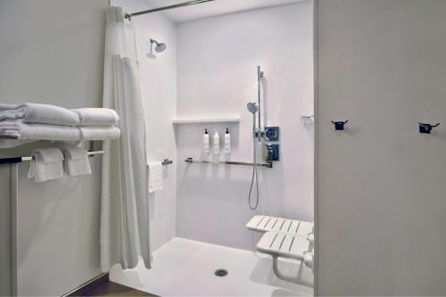 a white bathroom with a shower and a toilet at Fairfield by Marriott Inn & Suites Cincinnati North West Chester in West Chester