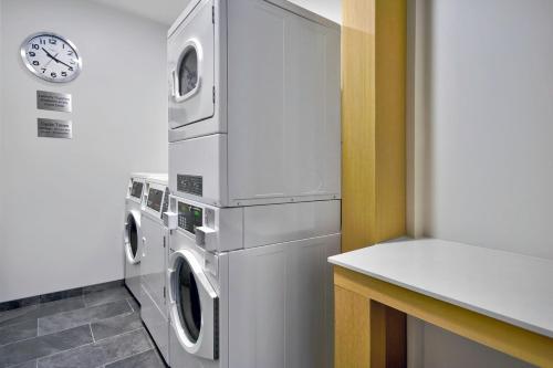 a kitchen with a washer and dryer and a clock at Fairfield by Marriott Inn & Suites Cincinnati North West Chester in West Chester