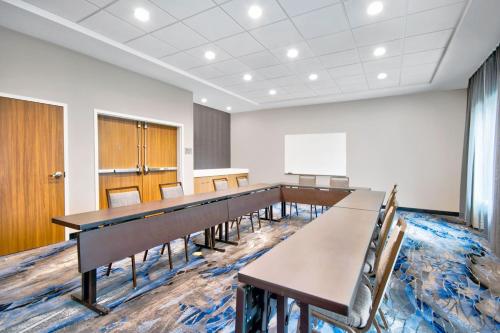 a conference room with tables and chairs and a whiteboard at Fairfield by Marriott Inn & Suites Cincinnati North West Chester in West Chester