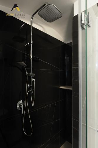 a shower with a shower head in a bathroom at ALIBI SUITES Loft: Centralissimo con Free WiFi, Netflix, A/C e tutti i Comfort in Ruvo di Puglia