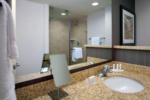 a bathroom with a sink and a large mirror at Courtyard by Marriott Philadelphia Lansdale in Lansdale