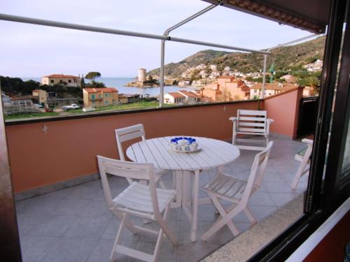 a table and chairs on a balcony with a view of the ocean at Ammiraglio in Campese