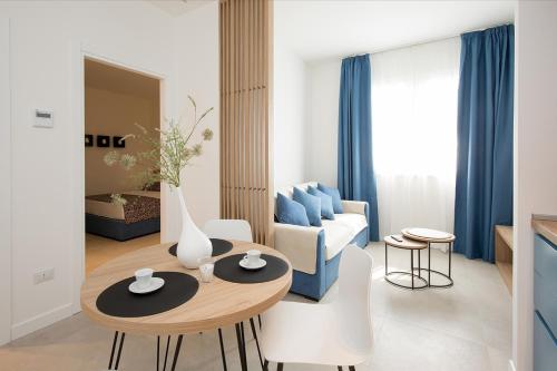 a living room with a table and a blue couch at Giada Luxury Terrasini in Terrasini