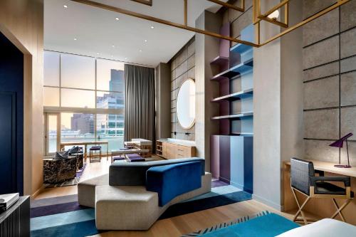 a living room with a blue couch and a table at W Montreal in Montreal