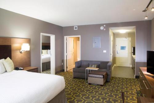 a hotel room with a bed and a living room at TownePlace Suites by Marriott Oxford in Oxford