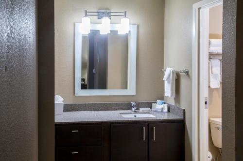 a bathroom with a sink and a mirror at TownePlace Suites by Marriott Oxford in Oxford