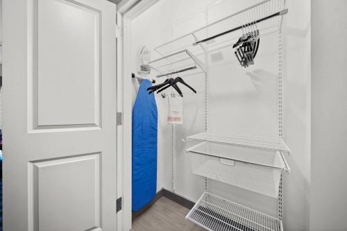 a closet with white shelves and a blue dress at TownePlace Suites Waco Northeast in Waco