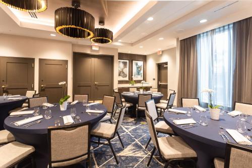 a dining room with tables and chairs in a room at Residence Inn Palm Beach Gardens in Palm Beach Gardens