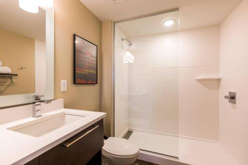 a bathroom with a sink and a toilet and a shower at TownePlace Suites by Marriott Portland Beaverton in Beaverton