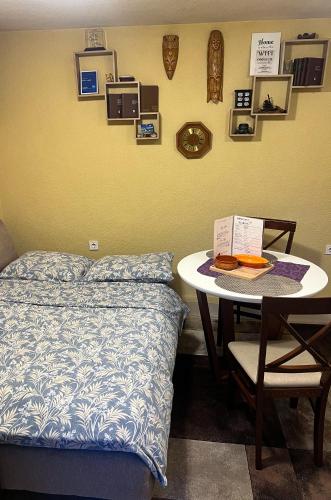 a bedroom with a bed and a small table with a tableablish at Green Hills II by Rent a car MI in Podgorica