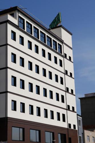 a white building with a sign on top of it at Hotel Continental in Reggio Calabria