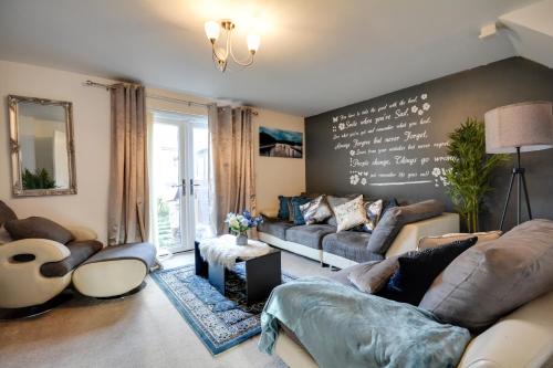 a living room with couches and a chalkboard wall at Three Bedroom House in Runcorn Close To The Lake with Parking in Runcorn