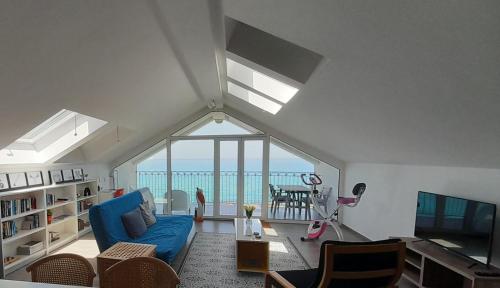 a living room with a blue couch and a tv at Marina Holiday Home in Pizzo