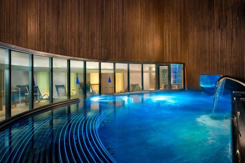 a large swimming pool in a large building at Sheraton Grand Hotel & Spa in Edinburgh