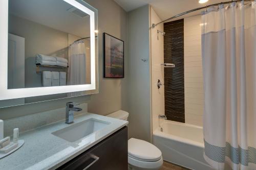 a bathroom with a sink and a toilet and a shower at TownePlace Suites by Marriott Mobile Saraland in Saraland