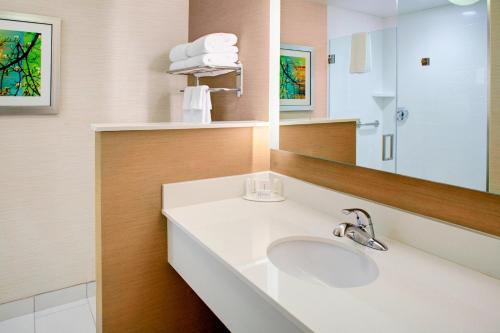 a bathroom with a sink and a mirror at Fairfield Inn & Suites by Marriott Flagstaff East in Flagstaff