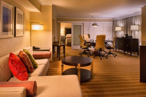 a living room with a couch and a table at Marriott Memphis East in Memphis