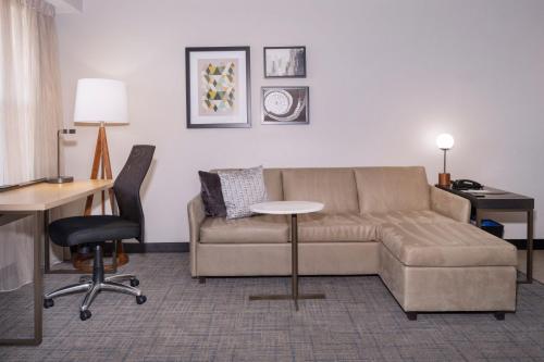 a living room with a couch and a table at Residence Inn Salt Lake City Airport in Salt Lake City