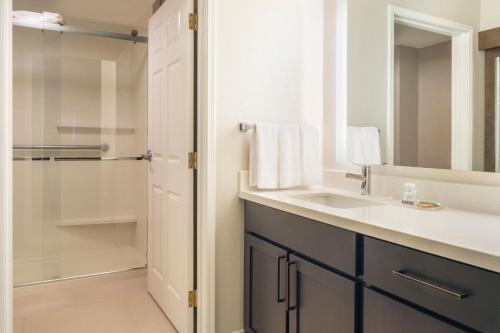 a bathroom with a sink and a shower at Residence Inn Salt Lake City Airport in Salt Lake City