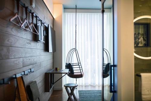 a room with a hanging chair and a window at Moxy NYC Downtown in New York