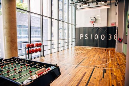 a room with a pool table and a basketball hoop at Moxy NYC Downtown in New York