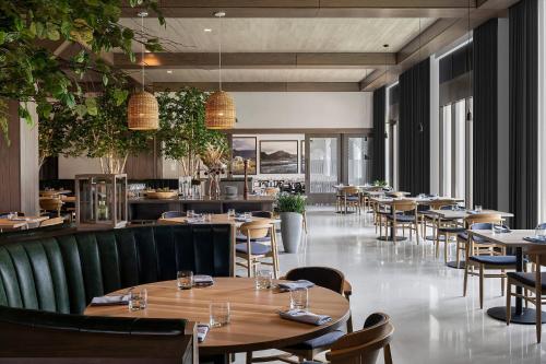 a restaurant with tables and chairs and a bar at Renaissance Milwaukee West Hotel in Wauwatosa