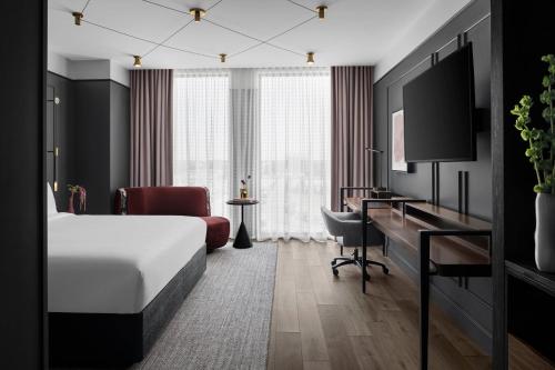 a hotel room with a bed and a desk at Renaissance Milwaukee West Hotel in Wauwatosa
