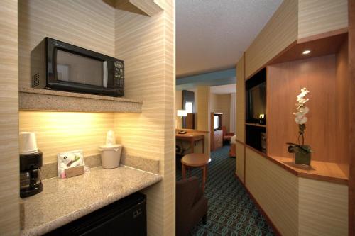 a hotel room with a television on the wall at Fairfield Inn & Suites by Marriott Edison - South Plainfield in Edison