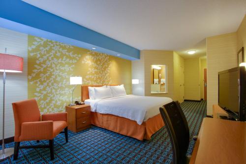 a hotel room with a bed and a flat screen tv at Fairfield Inn & Suites by Marriott Edison - South Plainfield in Edison