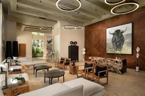 a living room with a cow painting on the wall at The Ocean Club, a Luxury Collection Resort, Costa Norte in Sosúa