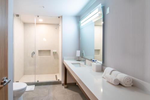 a bathroom with a toilet and a sink and a shower at Courtyard by Marriott Mexicali in Mexicali