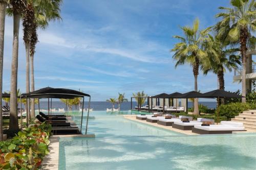 an image of a resort swimming pool with palm trees at The Ocean Club, a Luxury Collection Resort, Costa Norte in Sosúa