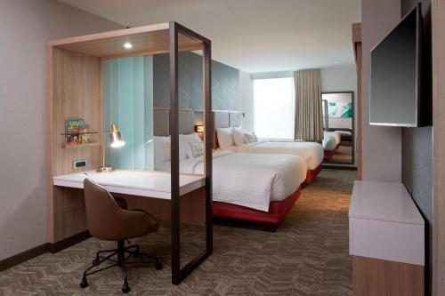 a hotel room with two beds and a desk at SpringHill Suites by Marriott East Lansing University Area, Lansing Area in East Lansing