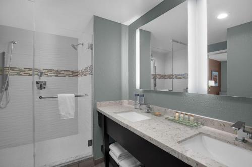 a bathroom with a sink and a shower at Renaissance Indianapolis North Hotel in Carmel