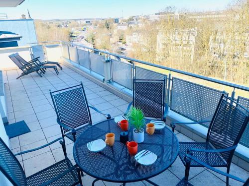 a balcony with a table and chairs on a roof at Big Penthouse 2 Bedrooms in Center with Parking and LargeTerrace-41 in Luxembourg