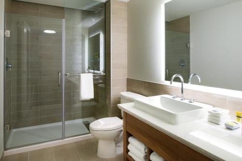 a bathroom with a toilet and a sink and a shower at Element Kansas City Overland Park in Leawood