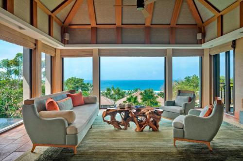 a living room with two couches and a table at The Ritz-Carlton Bali in Nusa Dua