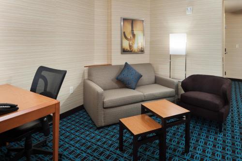 a living room with a couch and a chair at Fairfield Inn and Suites Phoenix Chandler Fashion Center in Chandler
