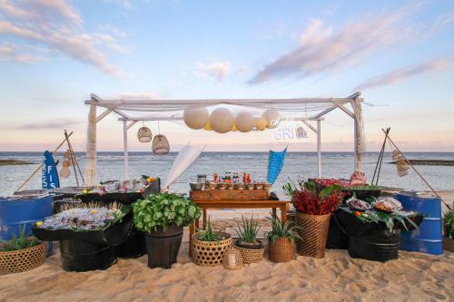 a stand on the beach with flowers and plants at The Ritz-Carlton Bali in Nusa Dua