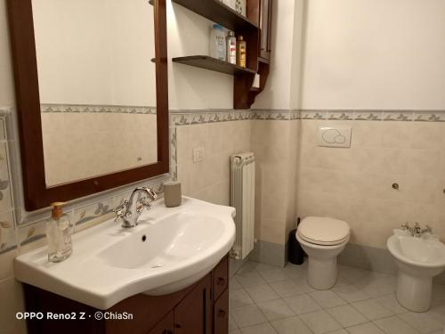 a bathroom with a sink and a toilet at A Casa di Marti in Loreto