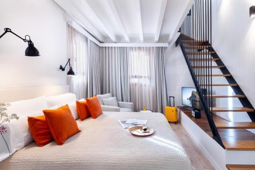 a living room with a white couch and a staircase at Samaritana Suites in Palma de Mallorca