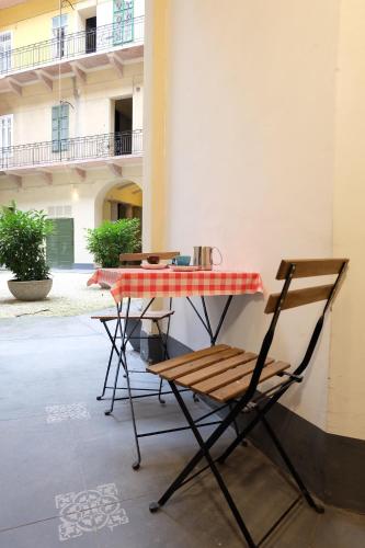 布達佩斯的住宿－藝術與設計公寓，桌子和椅子以及红白格子的桌椅