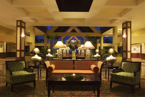 a lobby with a couch and two chairs and a table at Miri Marriott Resort & Spa in Miri